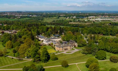 An aerial view of Rudding Park, near Harrogate, which is surrounded by trees and lawns.