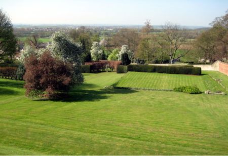 View of gardens looking across grassed lawns to the landscape beyond